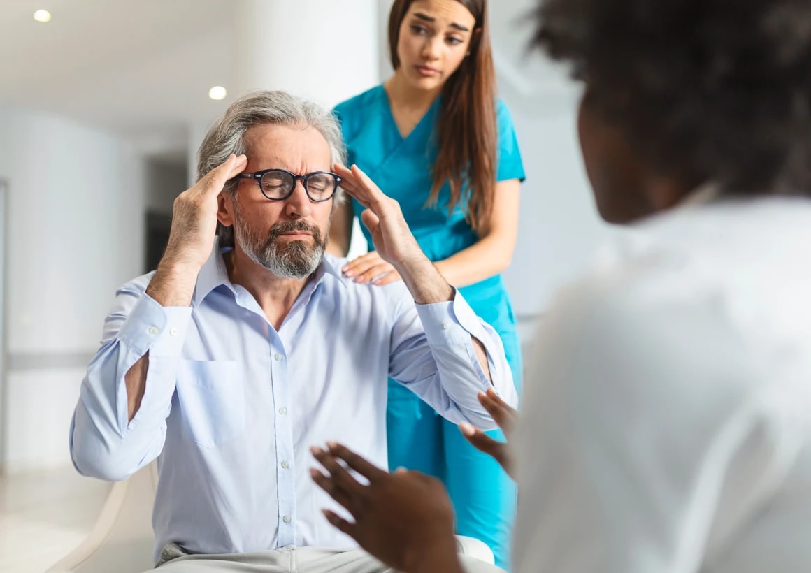 A clinician supporting a patient during an assessment session