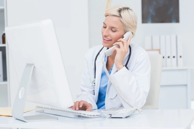 Behavioral health clinician on a phone call reviewing a practice's billing