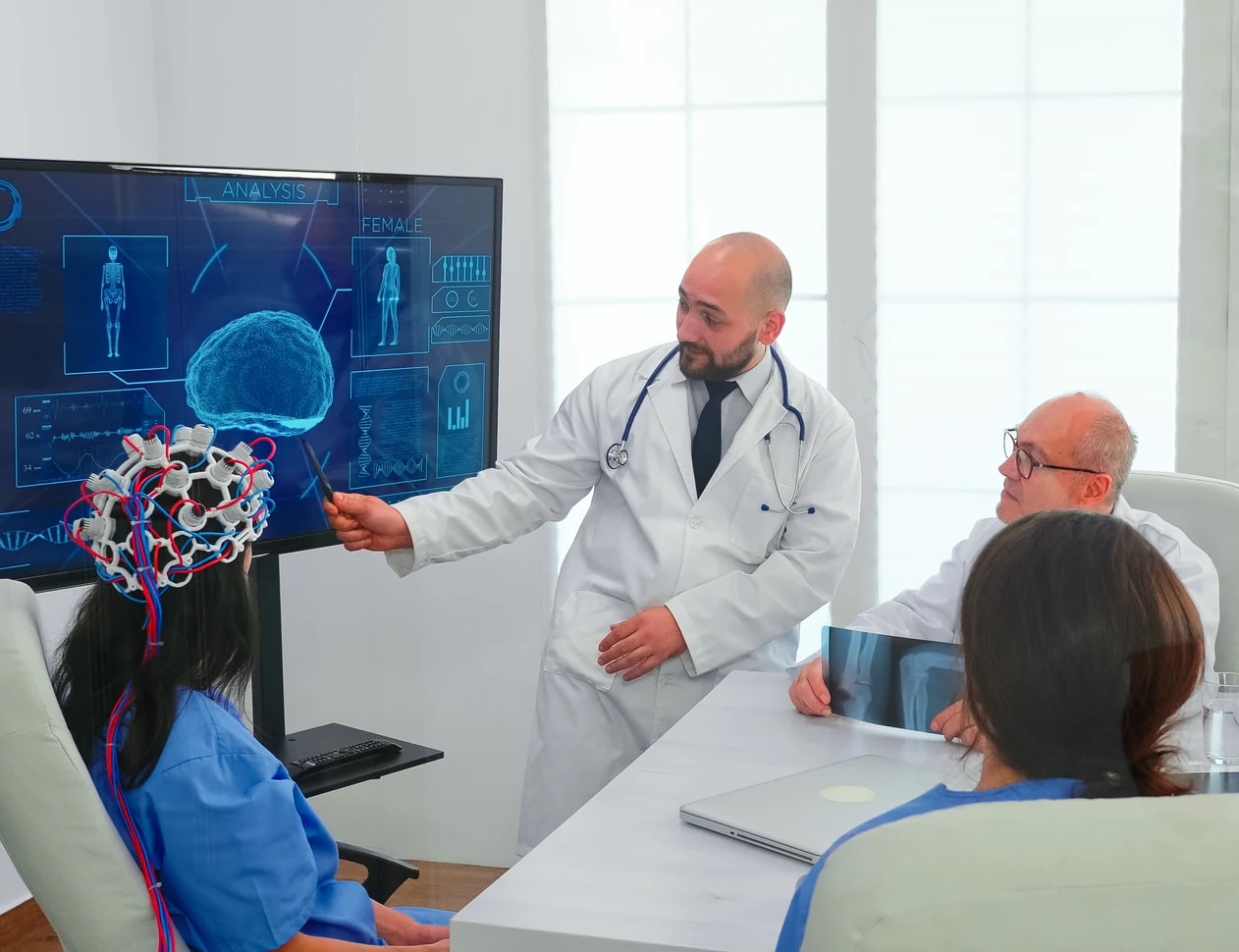 A clinician presenting a brain imaging review to colleagues