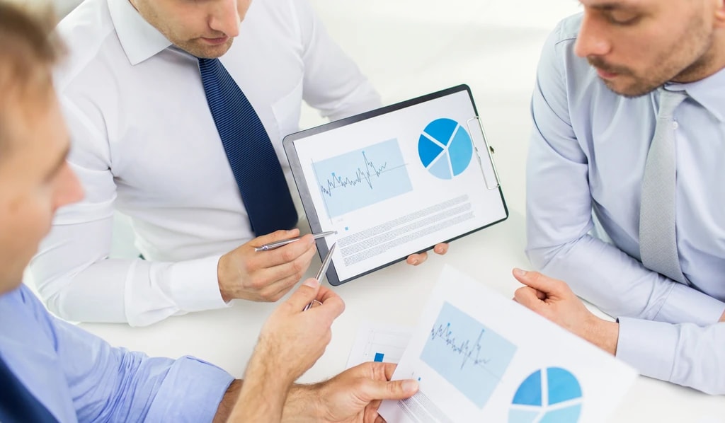 Two specialists reviewing revenue cycle reporting